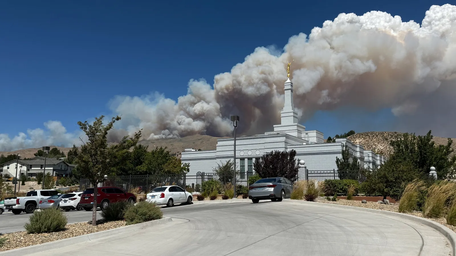 Smoke from the Hawk Fire rises over the hills behind the Reno Nevada Temple, August 2026.
